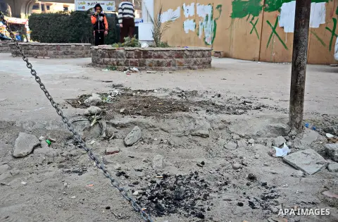 An Egyptian boy stands watch at the scene after defused a bomb by civil protection forces in al-Haram street, near Cairo, December 5, 2014. Photo by Amr Sayed