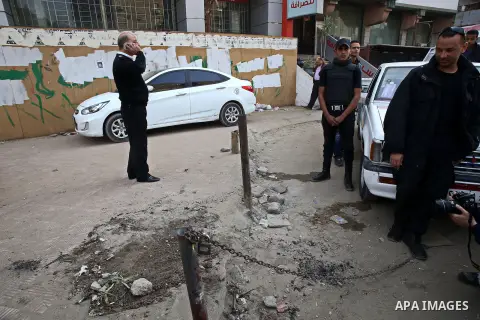 Egyptian police and investigators stand at the scene after defused a bomb in al-Haram street, near Cairo, December 5, 2014. Photo by Amr Sayed