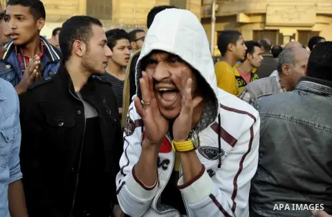 Egyptian protesters shout slogans on Abdel Moneim Riad Square in the capital Cairo on December 5, 2014, during a demonstration against a court's decision to drop a murder charge against ousted president Hosni Mubarak. A...