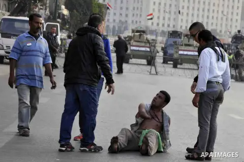 A Egyptian protester clashes with a pro-regime supporter during a demonstration denouncing a recent court's decision to drop a murder charge against the former president, on December 5, 2014, on Abdel Moneim Riad Square...