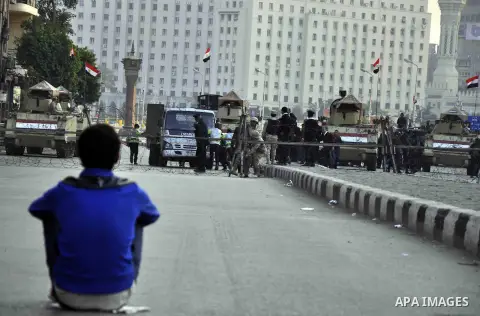 Egyptian army blocks a road leading to Cairo's landmark Tahrir Square on December 5, 2014, during a demonstration against a court's decision to drop a murder charge against ousted president Hosni Mubarak. A Cairo court o...