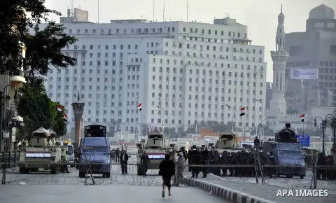 Egyptian army blocks a road leading to Cairo's landmark Tahrir Square on December 5, 2014, during a demonstration against a court's decision to drop a murder charge against ousted president Hosni Mubarak. A Cairo court o...