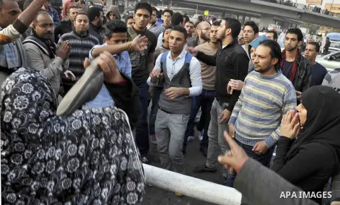 Egyptian protesters shout slogans on Abdel Moneim Riad Square in the capital Cairo on December 5, 2014, during a demonstration against a court's decision to drop a murder charge against ousted president Hosni Mubarak. A...