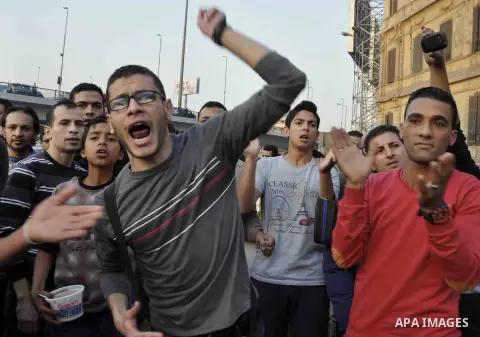Egyptian protesters shout slogans on Abdel Moneim Riad Square in the capital Cairo on December 5, 2014, during a demonstration against a court's decision to drop a murder charge against ousted president Hosni Mubarak. A...