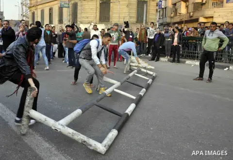 Egyptian protesters shout slogans on Abdel Moneim Riad Square in the capital Cairo on December 5, 2014, during a demonstration against a court's decision to drop a murder charge against ousted president Hosni Mubarak. A...
