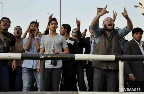 Egyptian protesters shout slogans on Abdel Moneim Riad Square in the capital Cairo on December 5, 2014, during a demonstration against a court's decision to drop a murder charge against ousted president Hosni Mubarak. A...