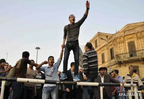 Egyptian protesters shout slogans on Abdel Moneim Riad Square in the capital Cairo on December 5, 2014, during a demonstration against a court's decision to drop a murder charge against ousted president Hosni Mubarak. A...
