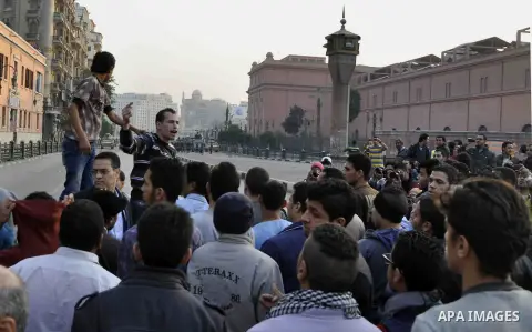 Egyptian protesters shout slogans on Abdel Moneim Riad Square in the capital Cairo on December 5, 2014, during a demonstration against a court's decision to drop a murder charge against ousted president Hosni Mubarak. A...