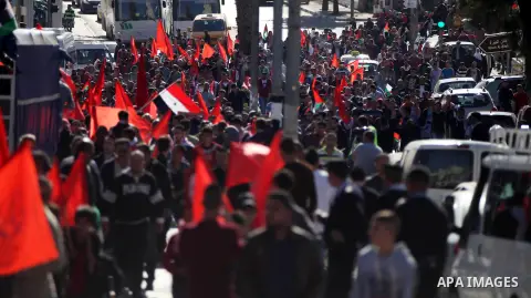 Palestinian supporters of the Popular Front for the Liberation of Palestine hold national flags during a rally to celebrate the 46th anniversary of its founding in the West Bank city of Ramallah, December 6, 2014. Photo...
