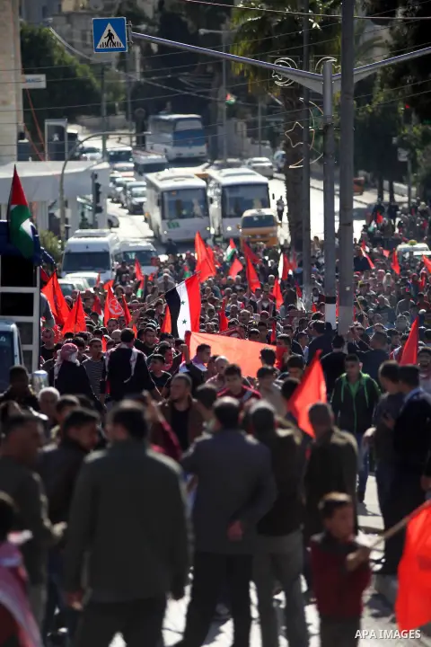 Palestinian supporters of the Popular Front for the Liberation of Palestine hold national flags during a rally to celebrate the 46th anniversary of its founding in the West Bank city of Ramallah, December 6, 2014. Photo...