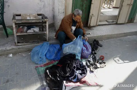 Palestinians looks at second hand clothes at a market in Rafah in the southern Gaza strip, December 06, 2014. Due to the current economic situation in Gaza Strip, many of the Palestinians resort to meet their needs of us...