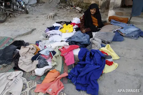 Palestinians looks at second hand clothes at a market in Rafah in the southern Gaza strip, December 06, 2014. Due to the current economic situation in Gaza Strip, many of the Palestinians resort to meet their needs of us...