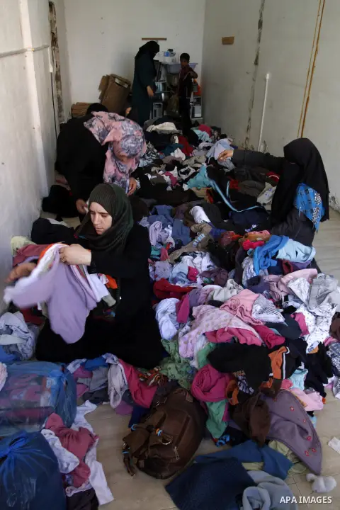 Palestinians looks at second hand clothes at a market in Rafah in the southern Gaza strip, December 06, 2014. Due to the current economic situation in Gaza Strip, many of the Palestinians resort to meet their needs of us...