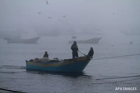 Palestinian fishermen ride their fishing boat at the seaport of Gaza City on December 7, 2014. Israeli forces detained 12 Palestinian fishermen off the coast of the northern Gaza Strip early Sunday. Photo by Mohammed Asa...