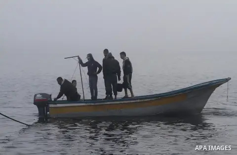 Palestinian fishermen ride their fishing boat at the seaport of Gaza City on December 7, 2014. Israeli forces detained 12 Palestinian fishermen off the coast of the northern Gaza Strip early Sunday. Photo by Mohammed Asa...