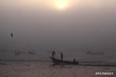 Palestinian fishermen ride their fishing boat at the seaport of Gaza City on December 7, 2014. Israeli forces detained 12 Palestinian fishermen off the coast of the northern Gaza Strip early Sunday. Photo by Mohammed Asa...