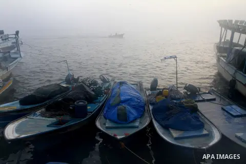 Palestinian fishermen ride their fishing boat at the seaport of Gaza City on December 7, 2014. Israeli forces detained 12 Palestinian fishermen off the coast of the northern Gaza Strip early Sunday. Photo by Mohammed Asa...