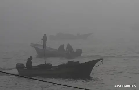 Palestinian fishermen ride their fishing boat at the seaport of Gaza City on December 7, 2014. Israeli forces detained 12 Palestinian fishermen off the coast of the northern Gaza Strip early Sunday. Photo by Mohammed Asa...