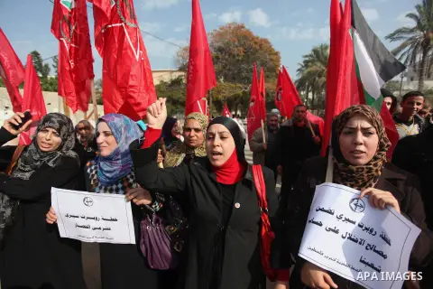 Palestinian supporters of the Popular Front for the Liberation of Palestine (PFLP) gather during a protest against the delay in acquiring building material in front of the United Nations office in Gaza city on December 7...