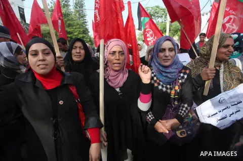 Palestinian supporters of the Popular Front for the Liberation of Palestine (PFLP) gather during a protest against the delay in acquiring building material in front of the United Nations office in Gaza city on December 7...