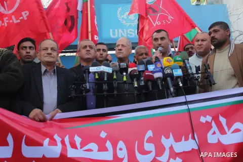 Palestinian supporters of the Popular Front for the Liberation of Palestine (PFLP) gather during a protest against the delay in acquiring building material in front of the United Nations office in Gaza city on December 7...