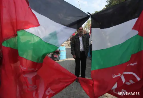 Palestinian supporters of the Popular Front for the Liberation of Palestine (PFLP) gather during a protest against the delay in acquiring building material in front of the United Nations office in Gaza city on December 7...