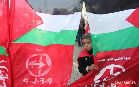 Palestinian supporters of the Popular Front for the Liberation of Palestine (PFLP) gather during a protest against the delay in acquiring building material in front of the United Nations office in Gaza city on December 7...