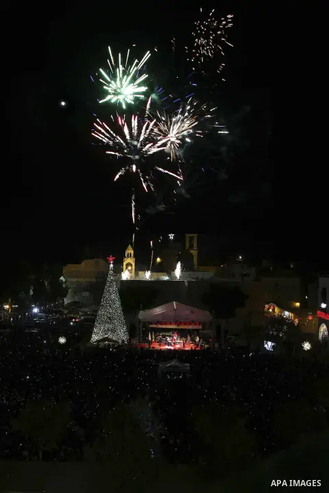 Fireworks explode during a Christmas tree lighting ceremony outside the Church of the Nativity in the West Bank town of Bethlehem December 6, 2014. Christians Pilgrims and tourists are expected to visit Bethlehem, the al...