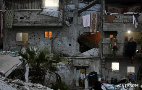 A Palestinian man stands at the entrance of his house, which was destroyed during the recent Israeli offensive on Gaza Strip, in Shijaiyah neighborhood, east Gaza City, December 8, 2014. According to housing minister Muf...