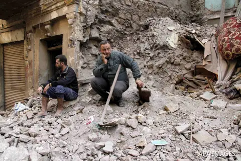 Egyptians and rescue workers inspect the site of a collapsed two-storey building in the Cairo district of Torgoman, December 9, 2014. The Ministry of Health and Population of Egypt injuring two people in the collapse of...