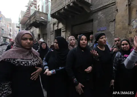 Egyptians and rescue workers inspect the site of a collapsed two-storey building in the Cairo district of Torgoman, December 9, 2014. The Ministry of Health and Population of Egypt injuring two people in the collapse of...