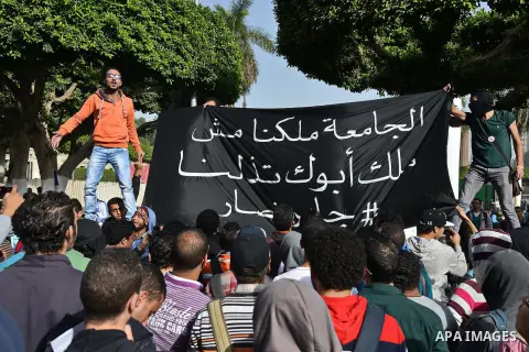 Egyptian students, who are members of Students Against the Coup group (SAC), take part in a demonstration against the military rule, at Cairo University on December 9, 2014. Photo by Amr Sayed