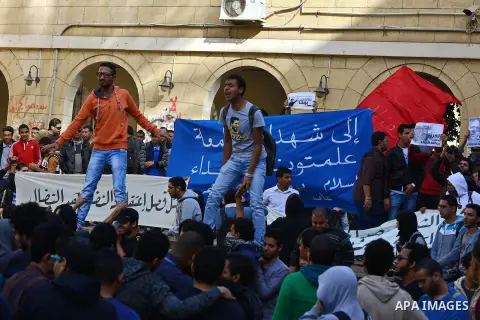 Egyptian students, who are members of Students Against the Coup group (SAC), take part in a demonstration against the military rule, at Cairo University on December 9, 2014. Photo by Amr Sayed