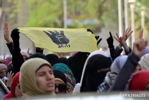 Egyptian students, who are members of Students Against the Coup group (SAC), take part in a demonstration against the military rule, at Cairo University on December 9, 2014. Photo by Amr Sayed