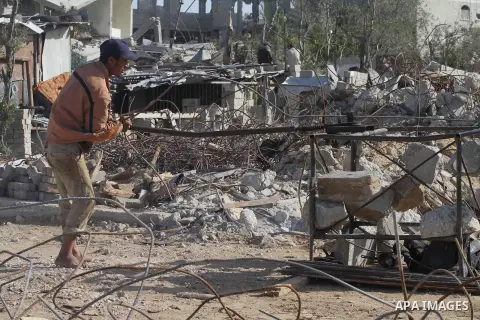 Palestinian workers extract iron from the rubbles of houses that witnesses said was destroyed by Israeli shelling during the most recent conflict between Israel and Hamas, in the east of Gaza City, December 10, 2014. Acc...