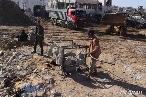 Palestinian workers extract iron from the rubbles of houses that witnesses said was destroyed by Israeli shelling during the most recent conflict between Israel and Hamas, in the east of Gaza City, December 10, 2014. Acc...