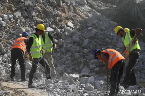 Palestinian workers remove the ruins of houses which were destroyed during the seven-week Israeli offensive on Gaza Strip, in Shijaeya neighborhood, east of Gaza city, December 10, 2014. According to housing minister Muf...