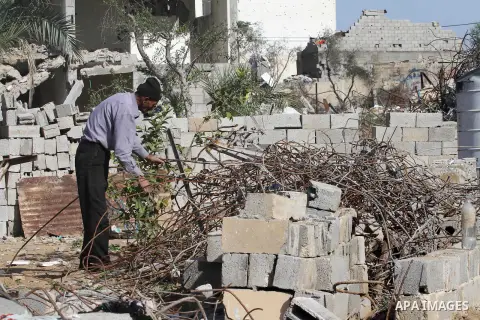 Palestinian workers extract iron from the rubbles of houses that witnesses said was destroyed by Israeli shelling during the most recent conflict between Israel and Hamas, in the east of Gaza City, December 10, 2014. Acc...
