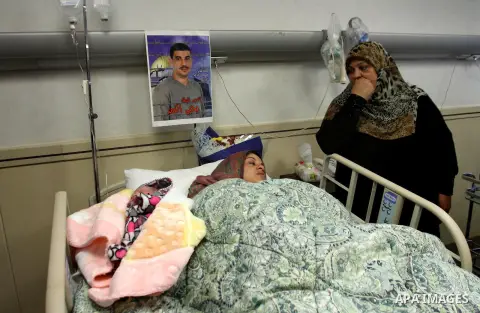 Samira, the wife of Palestinian prisoner Yahya al-Nemer, lies on a bed next to her baby girl Yasmeen, who was conceived with al-Nemer sperm smuggled out of an Israeli prison, at a hospital in the West Bank City of Nablus...