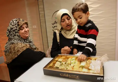 Relatives of Palestinian prisoner Yahya al-Nemer celebrate at a hospital in the West Bank City of Nablus December 12, 2014. Samira gave birth to her baby girl in a successful smuggling of sperm to lead to a pregnancy. Ph...
