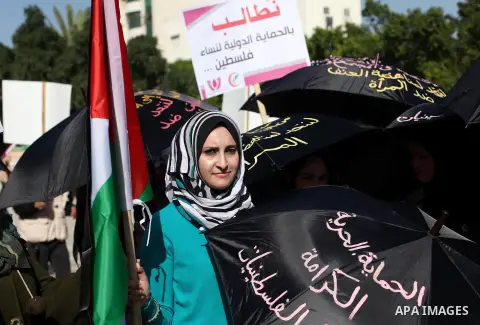 Palestinian women take part in a demonstration to mark the International Day of Human Rights, in Gaza City on December 10, 2014. The Palestinians are seeking a UN resolution by year-end that would set a timetable for Isr...