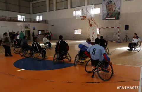 Disabled Palestinians play a basketball match during a championship organised by the Palestinian Red Cross to mark the International Day of Human Rights, in Khan Younis in the southern Gaza Strip, on December 10, 2014. T...