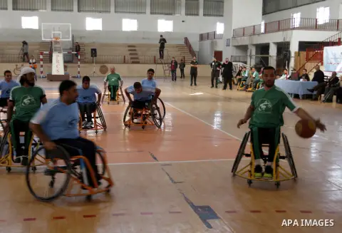 Disabled Palestinians play a basketball match during a championship organised by the Palestinian Red Cross to mark the International Day of Human Rights, in Khan Younis in the southern Gaza Strip, on December 10, 2014. T...
