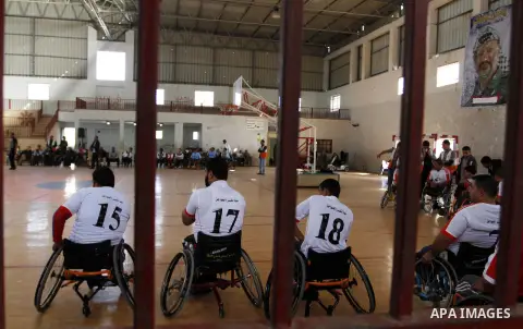Disabled Palestinians play a basketball match during a championship organised by the Palestinian Red Cross to mark the International Day of Human Rights, in Khan Younis in the southern Gaza Strip, on December 10, 2014. T...