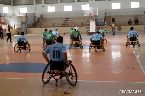 Disabled Palestinians play a basketball match during a championship organised by the Palestinian Red Cross to mark the International Day of Human Rights, in Khan Younis in the southern Gaza Strip, on December 10, 2014. T...