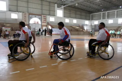 Disabled Palestinians play a basketball match during a championship organised by the Palestinian Red Cross to mark the International Day of Human Rights, in Khan Younis in the southern Gaza Strip, on December 10, 2014. T...