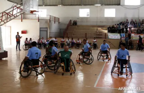 Disabled Palestinians play a basketball match during a championship organised by the Palestinian Red Cross to mark the International Day of Human Rights, in Khan Younis in the southern Gaza Strip, on December 10, 2014. T...