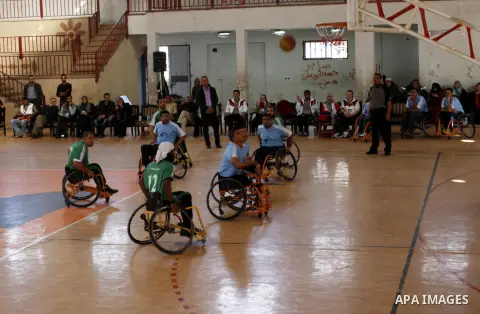 Disabled Palestinians play a basketball match during a championship organised by the Palestinian Red Cross to mark the International Day of Human Rights, in Khan Younis in the southern Gaza Strip, on December 10, 2014. T...