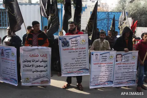 Palestinians take part in a demonstration is support of Palestinian prisoners held in Israeli jails, on Decembre 11, 2014 in Gaza City. Israel's parliament has passed a law that could block the release in any future peac...