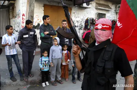 Palestinian militants from the Popular Front for the Liberation of Palestine (PFLP) take part in a military show to celebrate the 47th anniversary of the group's founding, in Khan Younis in the southern Gaza Strip Decemb...